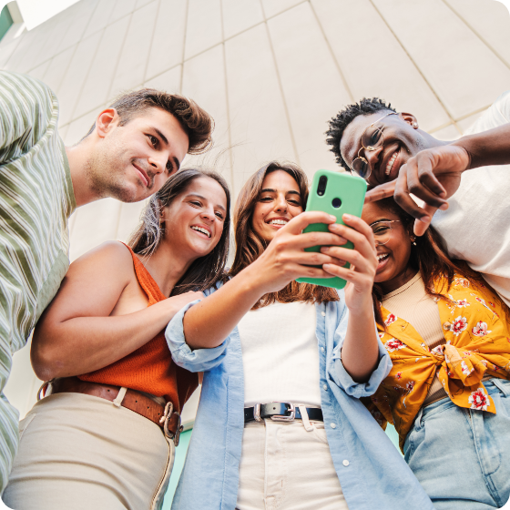 Group of young adults looking at a phone